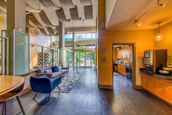A modern living room with a blue chair and a wooden table.